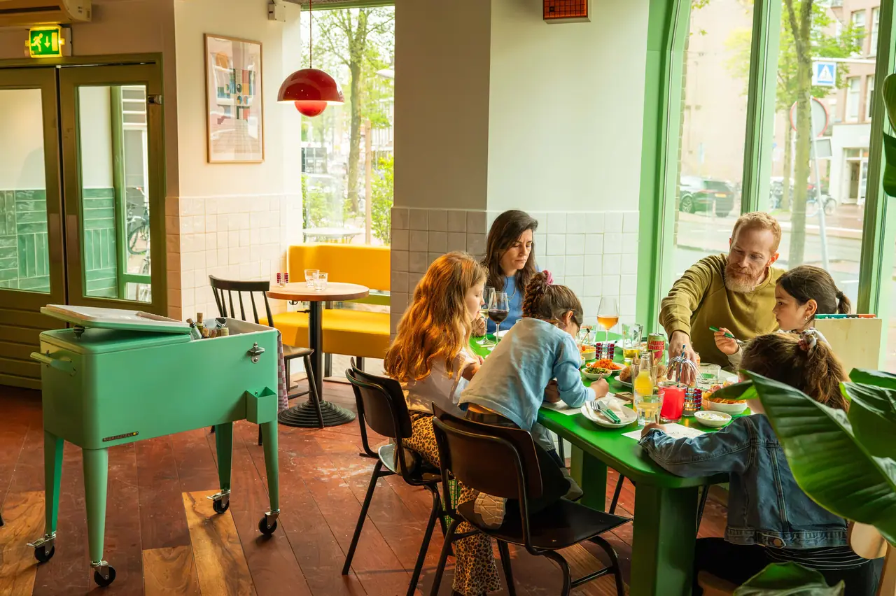 A family dinner at the green table by the window