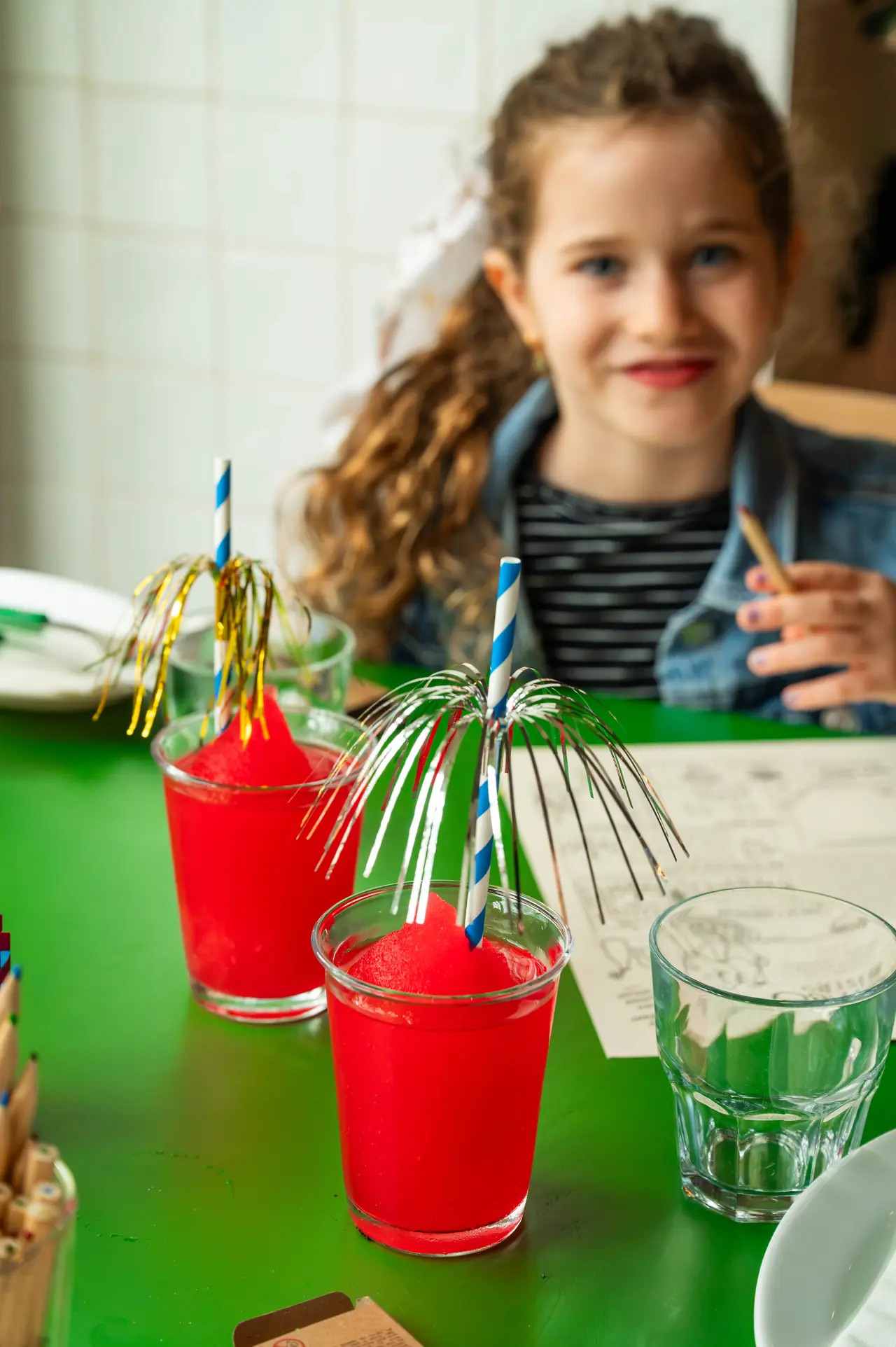 A girl smiling with a red drink