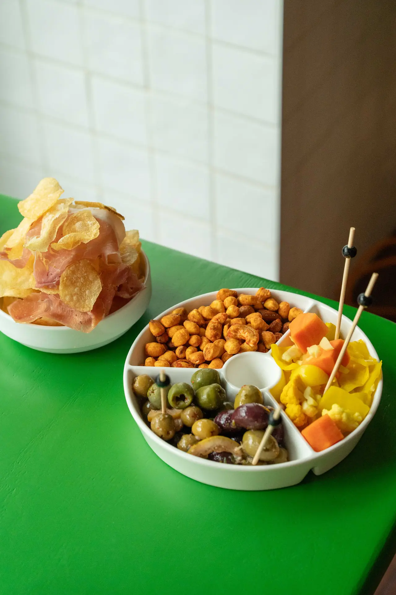 Snack trio of olives, nuts and pickles