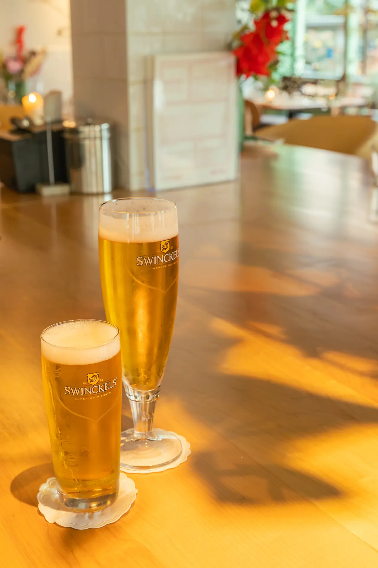 Two glasses of Swinckels pils on the bar